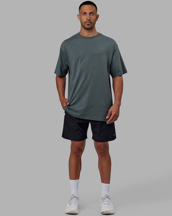 Man wearing Unisex PimaFLX Tee Oversize - Storm
