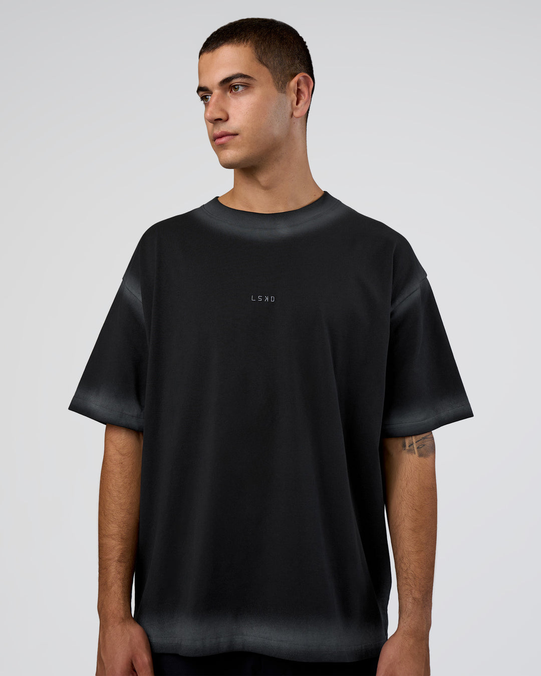 Man wearing Urban Blur Heavyweight Unisex Oversized Tee - Black-Dark Storm | Model:Zoran | Size:M