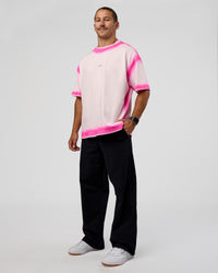 Man wearing Urban Blur Heavyweight Unisex Oversized Tee - Off White-Ultra Pink | Model:Jaiden | Size:M