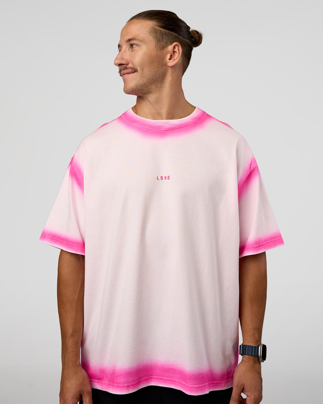 Man wearing Urban Blur Heavyweight Unisex Oversized Tee - Off White-Ultra Pink | Model:Jaiden | Size:M