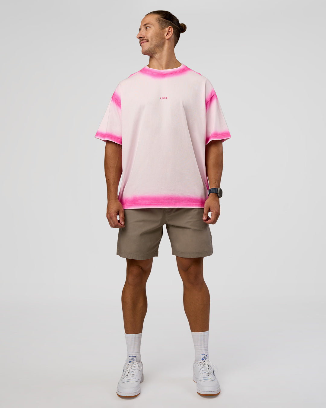 Man wearing Urban Blur Heavyweight Unisex Oversized Tee - Off White-Ultra Pink | Model:Jaiden | Size:M