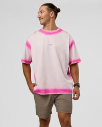 Man wearing Urban Blur Heavyweight Unisex Oversized Tee - Off White-Ultra Pink | Model:Jaiden | Size:M