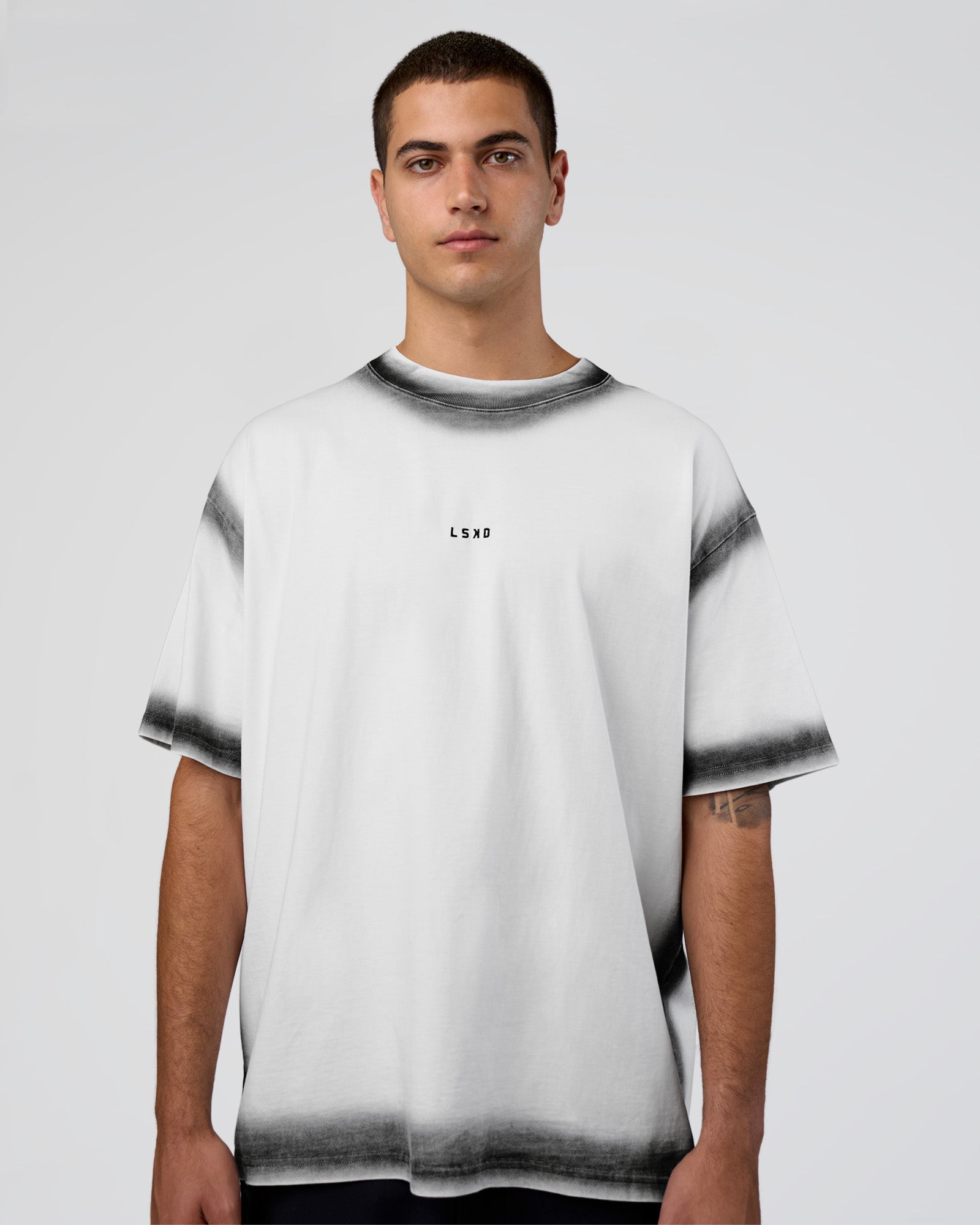 Man wearing Urban Blur Heavyweight Unisex Oversized Tee - White-Black | Model:Zoran | Size:M