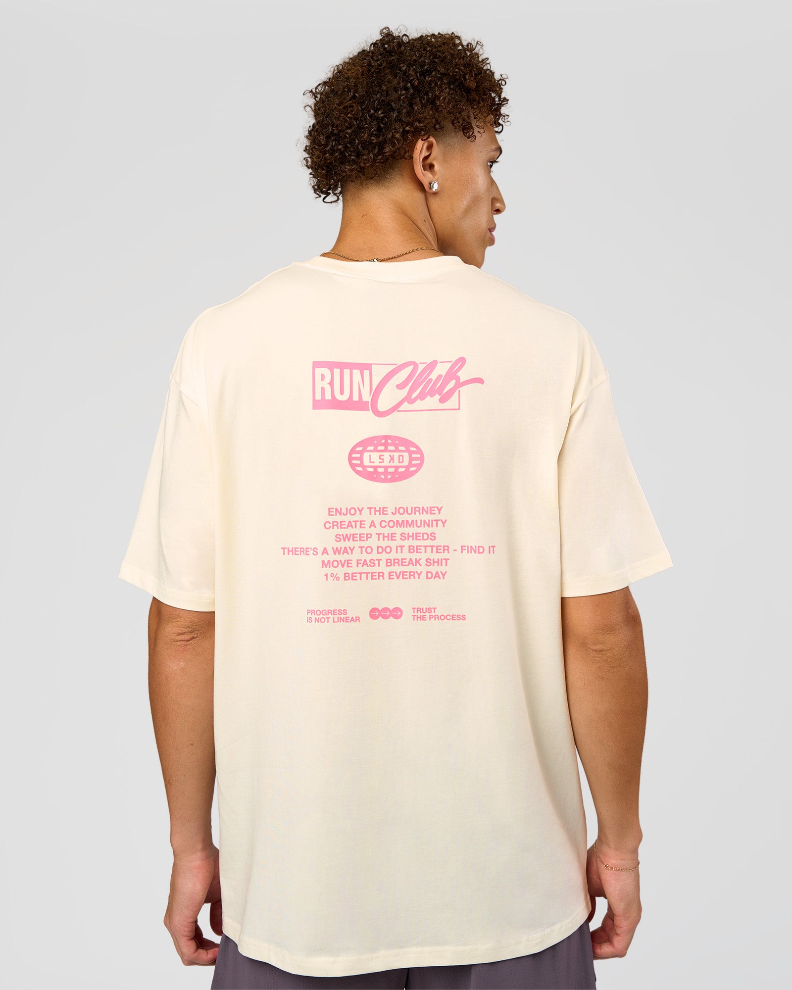 Man wearing Values Run Club FLXCotton Tee - Off White-Candy Pink | Model:Leandro | Size:M