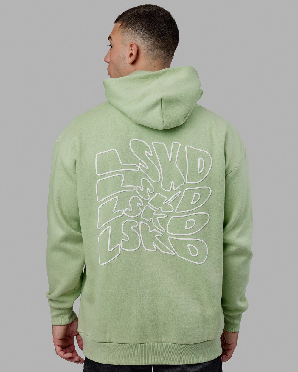 Man wearing Mad Happy Hoodie Oversize - Green Fig