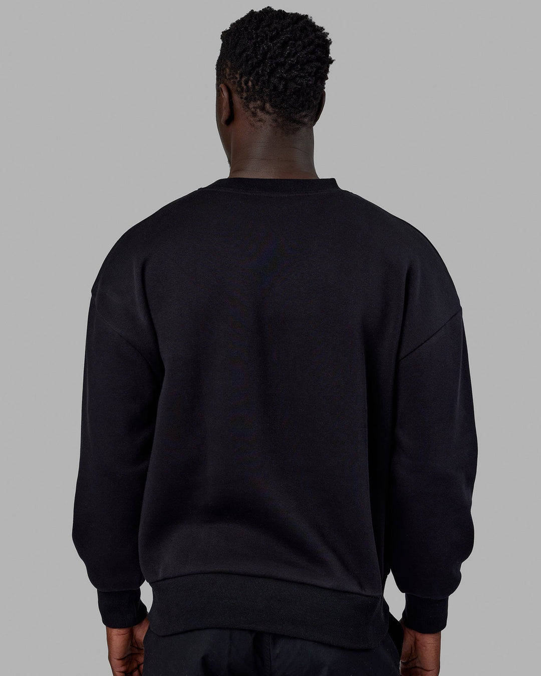 Man wearing Unisex 1% Better Sweater Oversize - Black-White