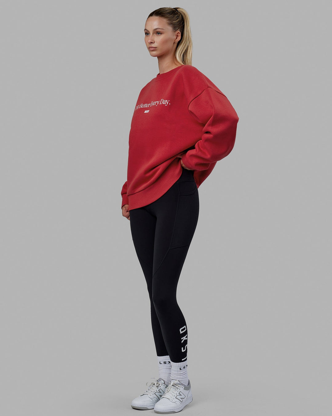 Woman wearing Unisex 1% Better Sweater Oversize - Cardinal