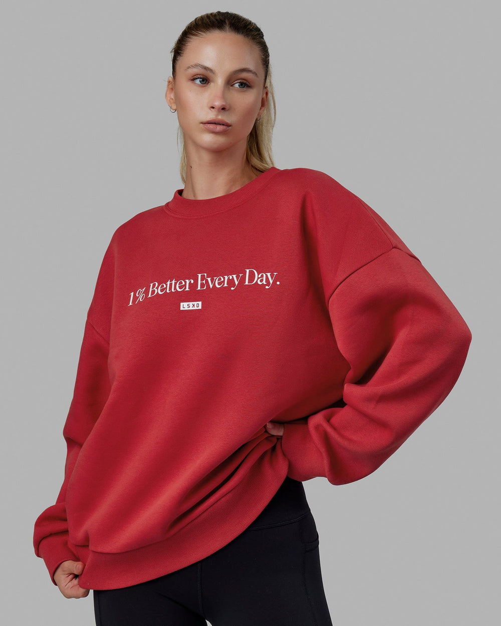 Woman wearing Unisex 1% Better Sweater Oversize - Cardinal