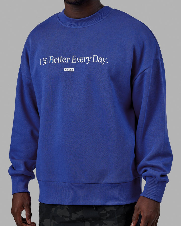 Man wearing Unisex 1% Better Sweater Oversize - Power Cobalt-White