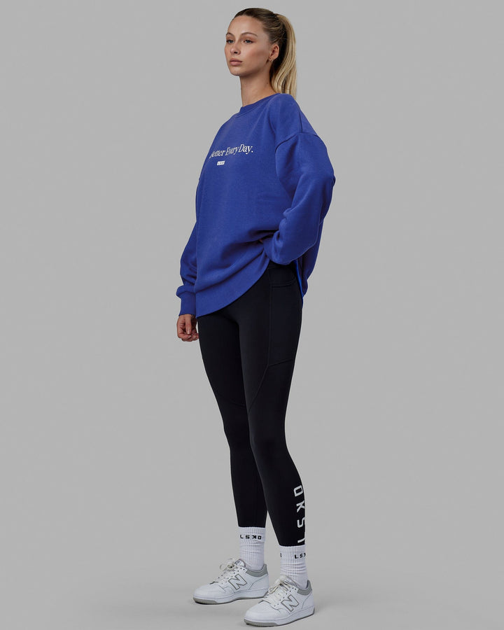 Woman wearing Unisex 1% Better Sweater Oversize - Power Cobalt-White