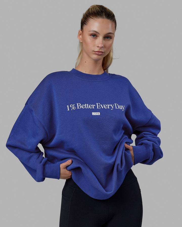 Woman wearing Unisex 1% Better Sweater Oversize - Power Cobalt-White