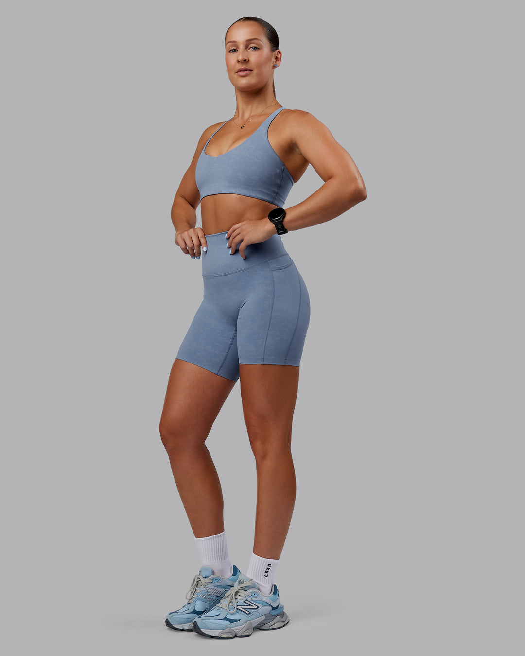 Woman wearing Abs Elixir Ultra High-Rise 6&quot; Short Pockets - Infinity Mirage