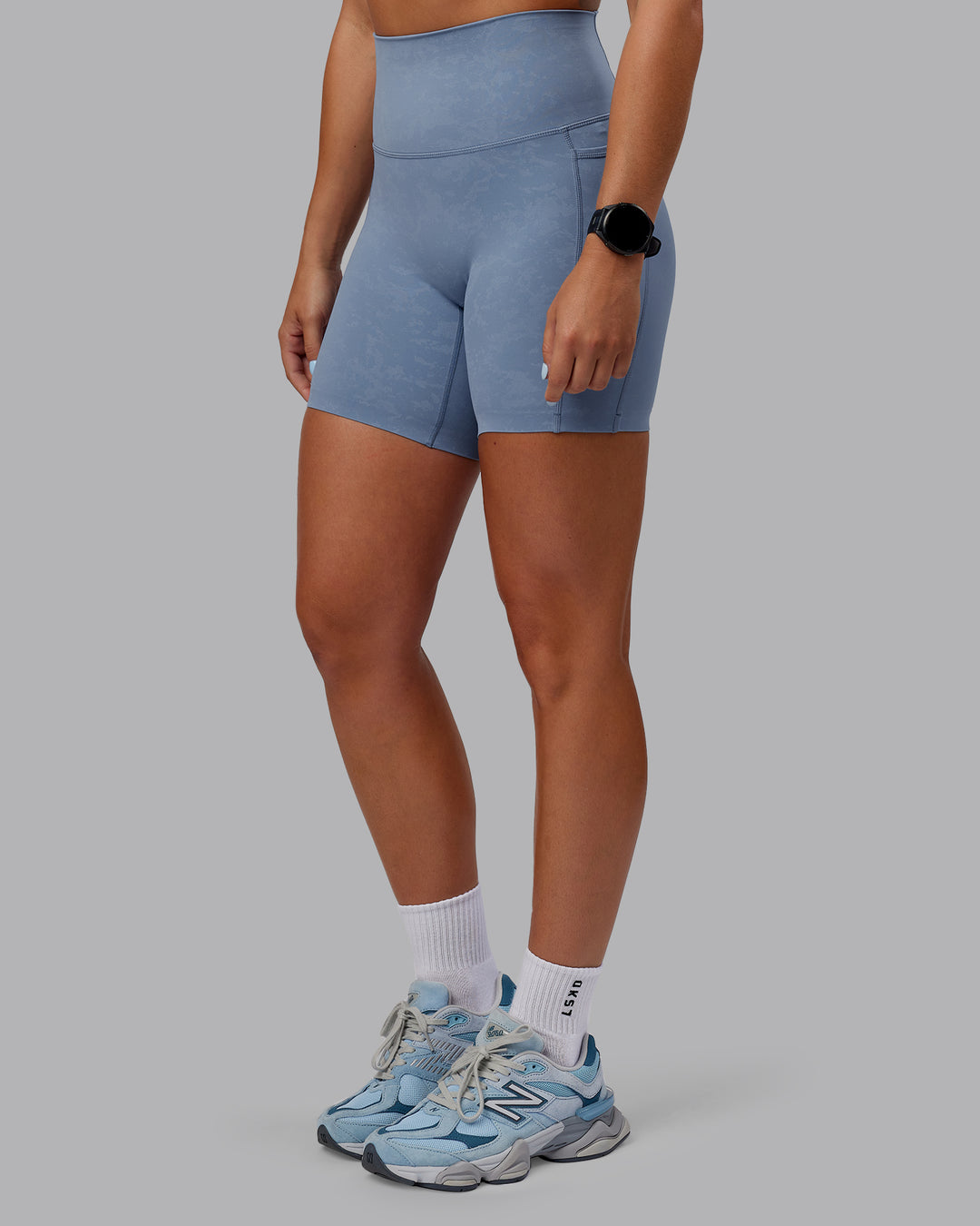 Woman wearing Abs Elixir Ultra High-Rise 6&quot; Short Pockets - Infinity Mirage