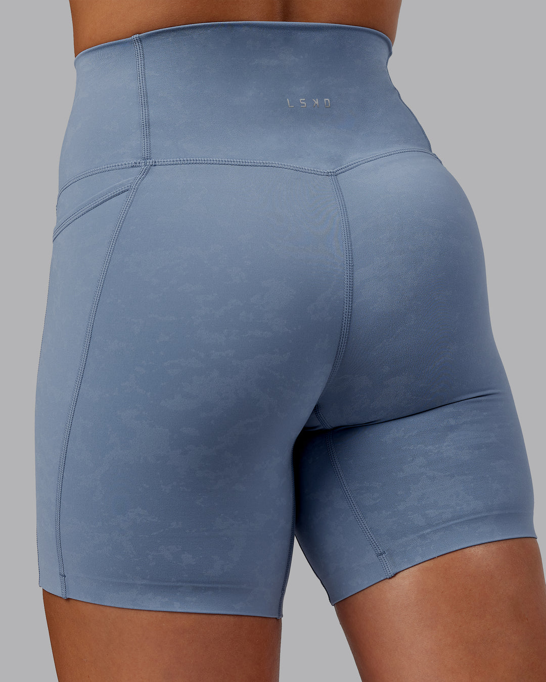 Woman wearing Abs Elixir Ultra High-Rise 6&quot; Short Pockets - Infinity Mirage