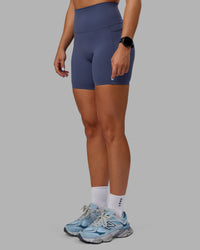 Woman wearing Abs Elixir Ultra High-Rise 6" Short Pockets - Nightshadow Blue