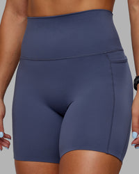 Woman wearing Abs Elixir Ultra High-Rise 6" Short Pockets - Nightshadow Blue