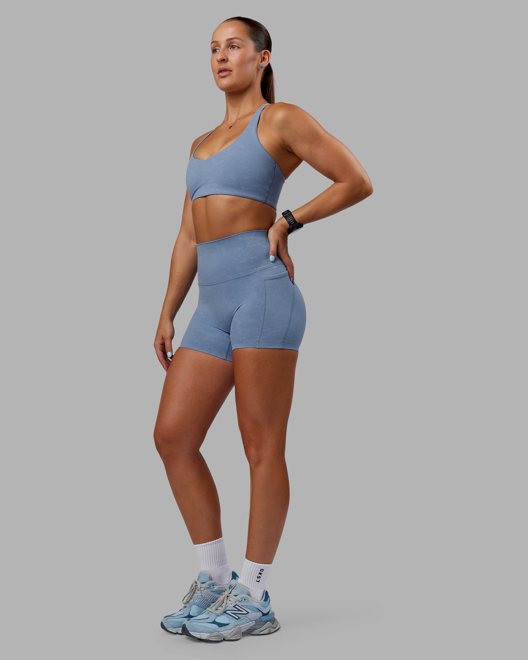 Woman wearing Abs Elixir Ultra High-Rise 4&quot; Short Pockets - Infinity Mirage
