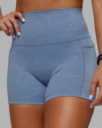 Woman wearing Abs Elixir Ultra High-Rise 4" Short Pockets - Infinity Mirage