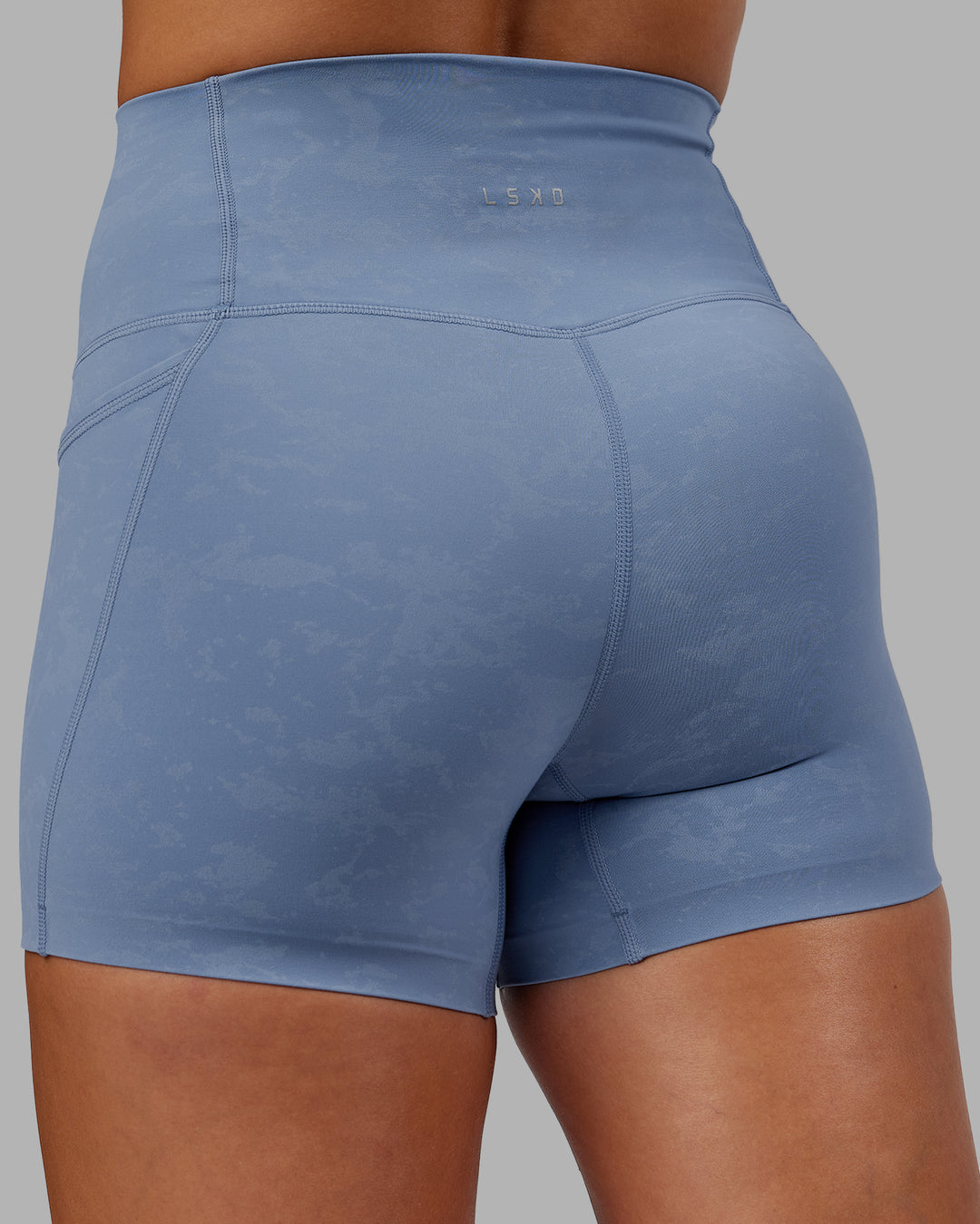 Woman wearing Abs Elixir Ultra High-Rise 4&quot; Short Pockets - Infinity Mirage