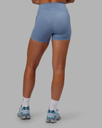 Woman wearing Abs Elixir Ultra High-Rise 4" Short Pockets - Infinity Mirage