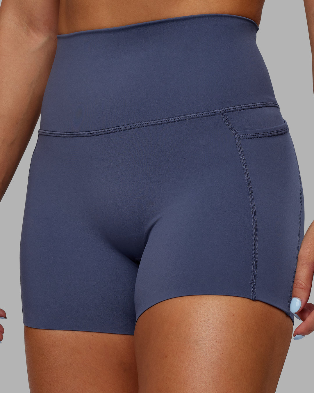 Woman wearing Abs Elixir Ultra High-Rise 4&quot; Short Pockets - Nightshadow Blue