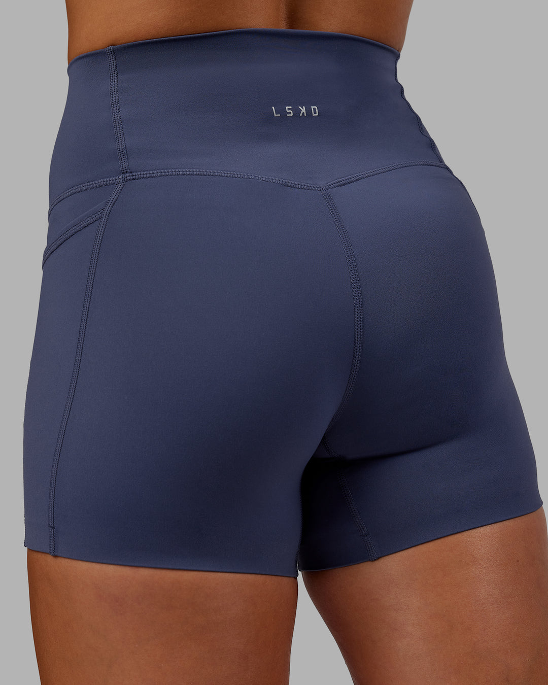 Woman wearing Abs Elixir Ultra High-Rise 4&quot; Short Pockets - Nightshadow Blue