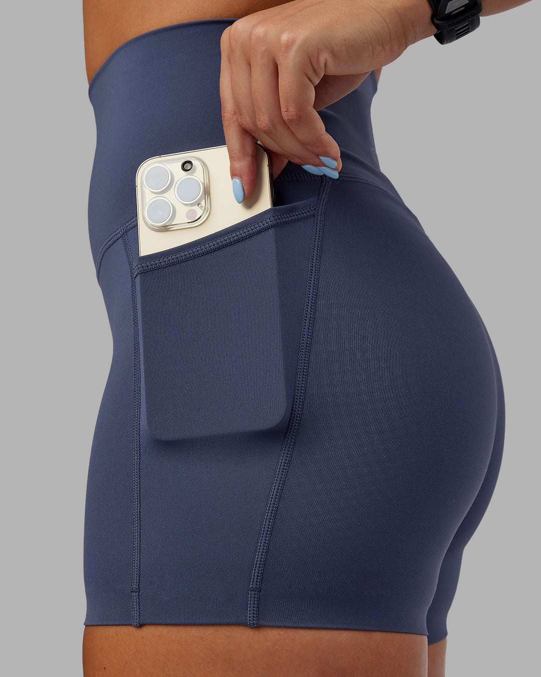 Woman wearing Abs Elixir Ultra High-Rise 4&quot; Short Pockets - Nightshadow Blue