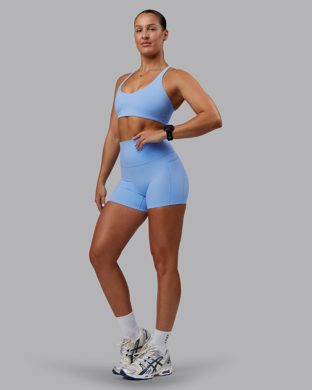 Woman wearing Abs Elixir Ultra High-Rise 4&quot; Short Pockets - Open Air