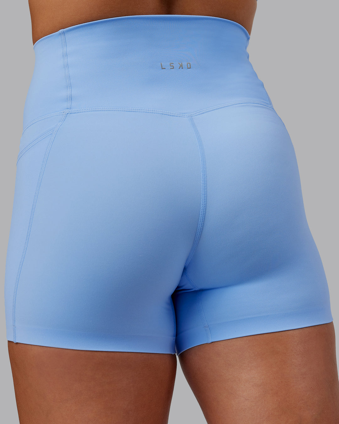 Woman wearing Abs Elixir Ultra High-Rise 4&quot; Short Pockets - Open Air