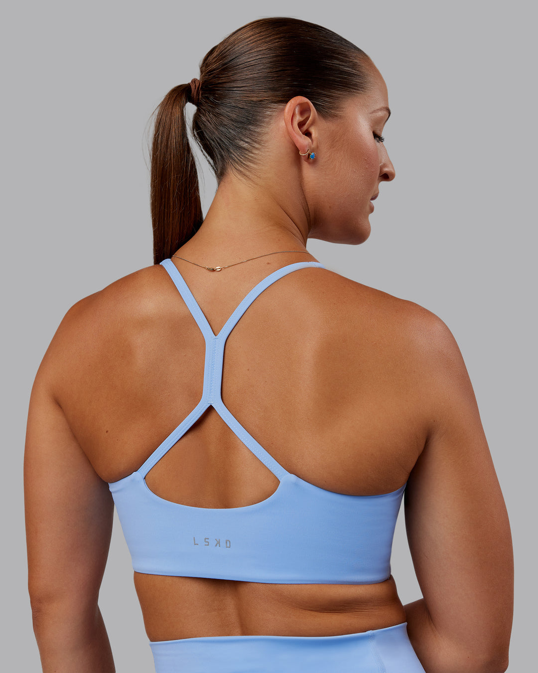 Woman wearing Abs Movement Sports Bra - Open Air