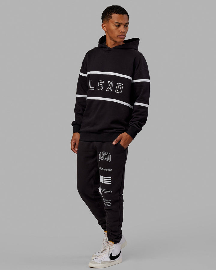 Man wearing Unisex Academy Track Pant - Black