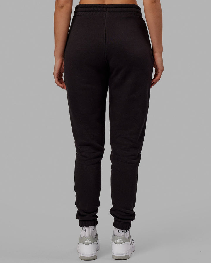 Woman wearing Unisex Academy Track Pant - Black