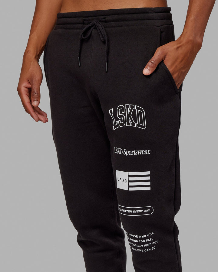 Man wearing Unisex Academy Track Pant - Black