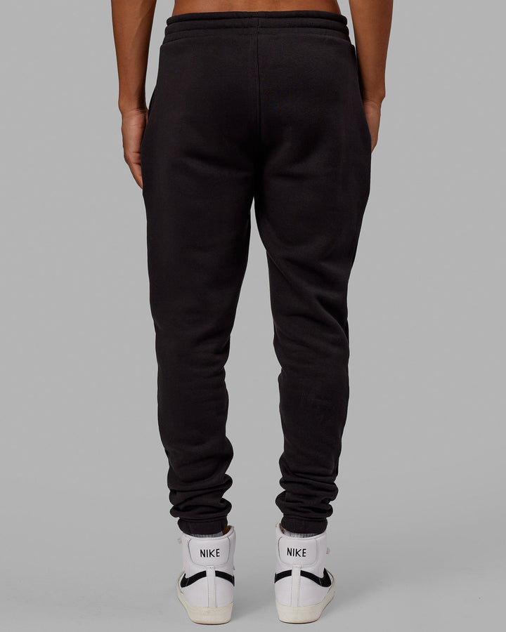 Man wearing Unisex Academy Track Pant - Black
