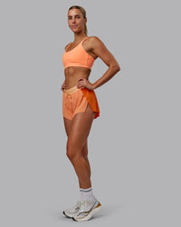 Woman wearing Accelerate 3" Run Shorts - Cantaloupe Colourblock