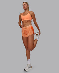 Woman wearing Accelerate 3" Run Shorts - Cantaloupe Colourblock