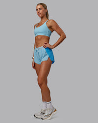 Woman wearing Accelerate 3" Run Shorts - Sky Blue Colourblock