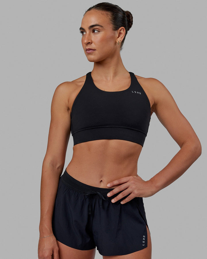 Woman wearing Accelerate Sports Bra - Black