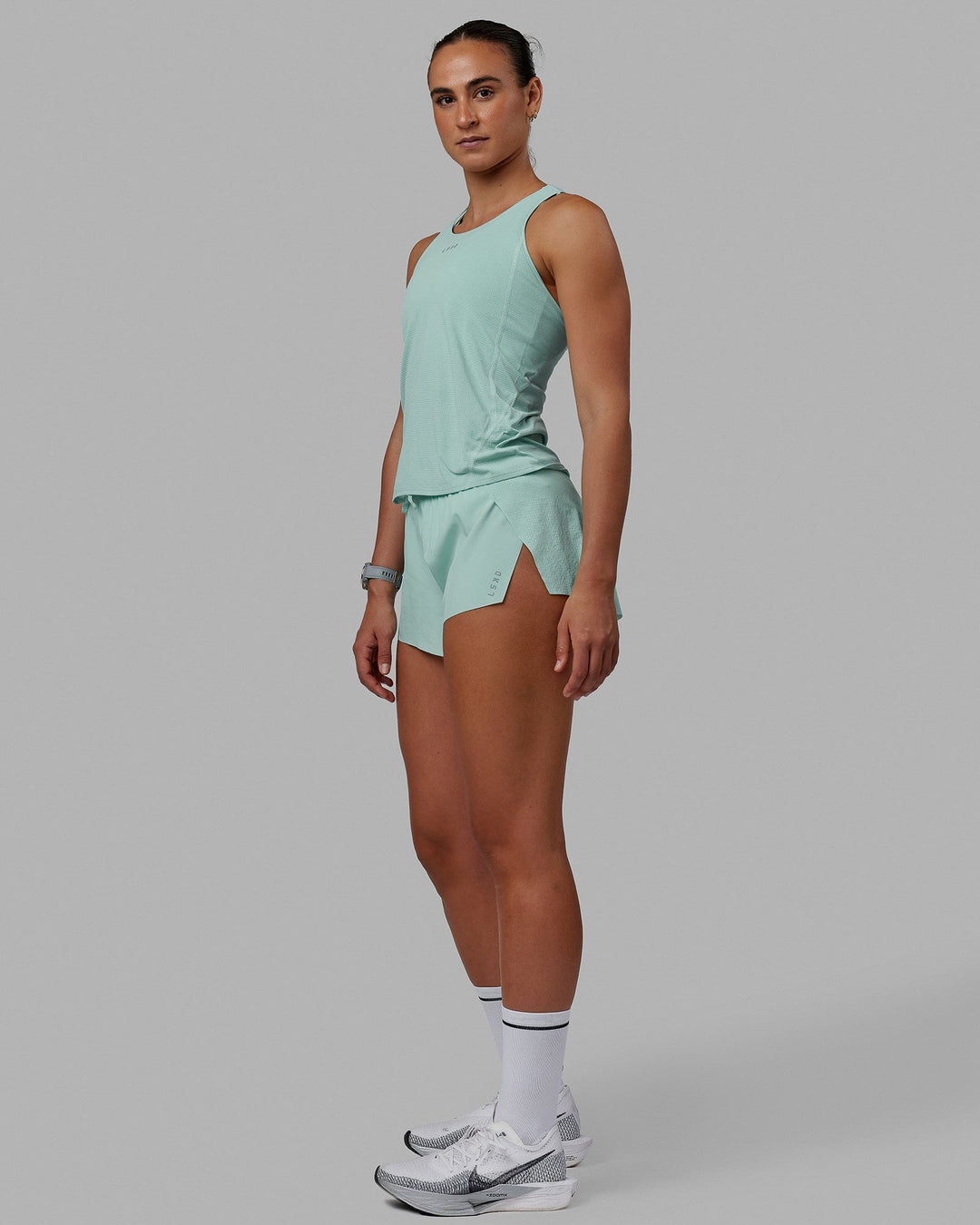 Woman wearing Accelerate Performance Tank - Pastel Turquoise