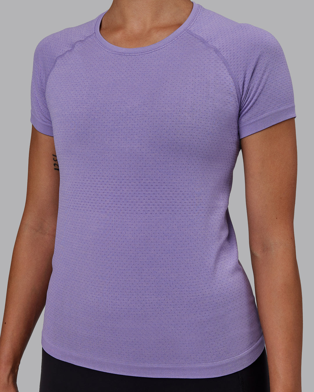 Woman wearing AeroFLX+ Seamless Tee - Dahlia Purple Marl