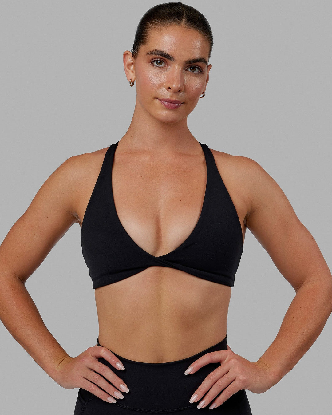 Woman wearing Agile Sports Bra - Black