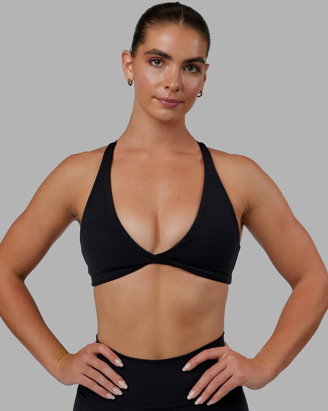 Woman wearing Agile Sports Bra - Black