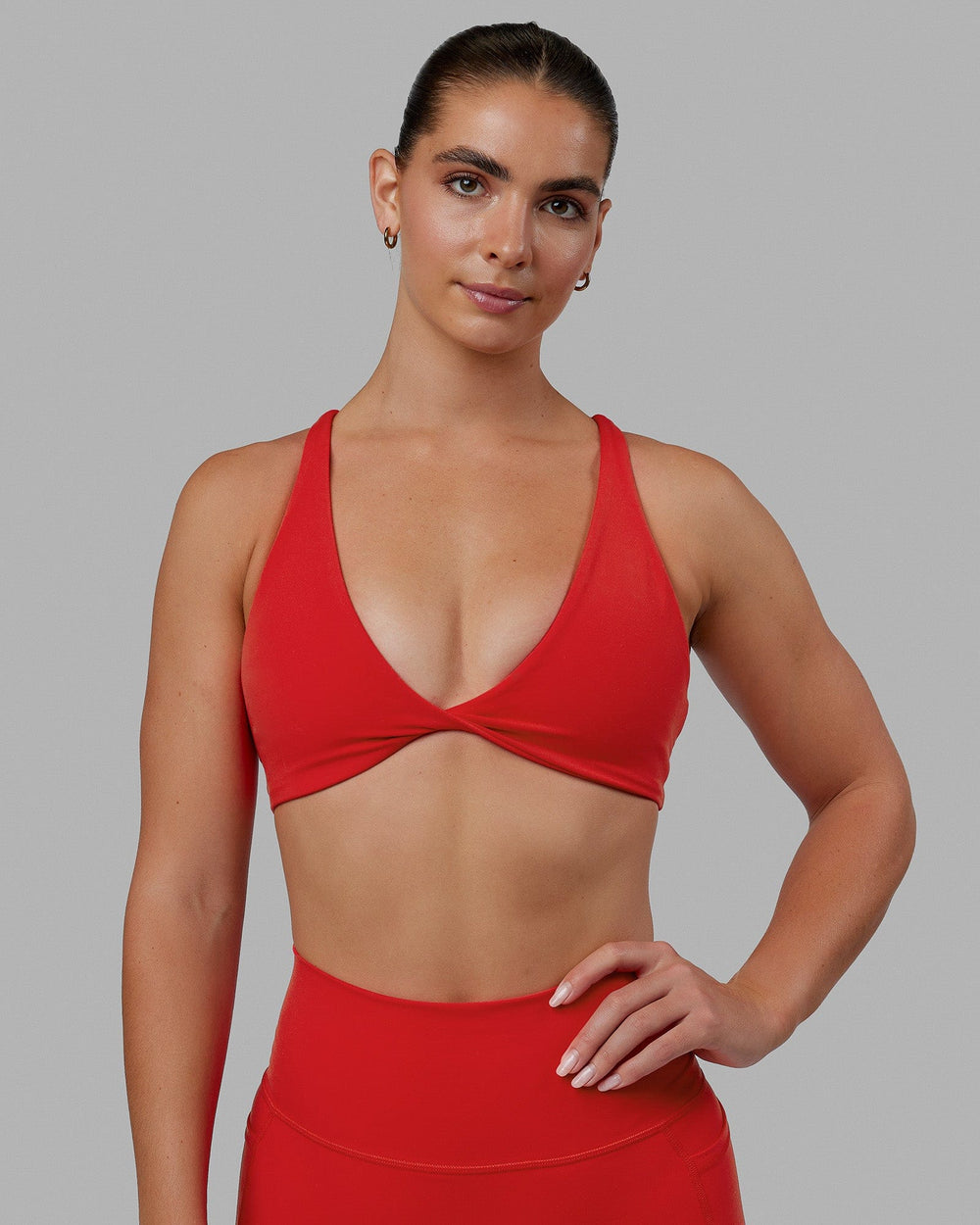 Woman wearing Agile Sports Bra - Infrared