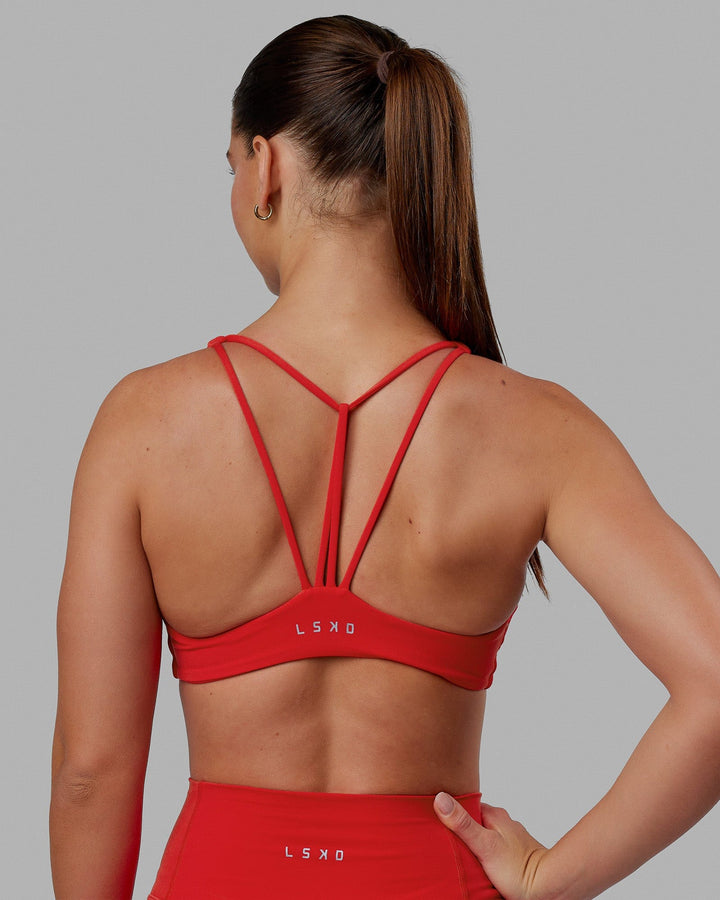 Woman wearing Agile Sports Bra - Infrared