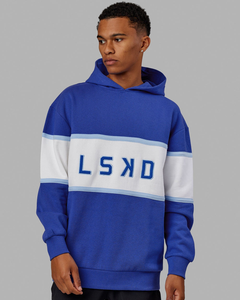 Man wearing Unisex Aligned Hoodie Oversize - Power Cobalt