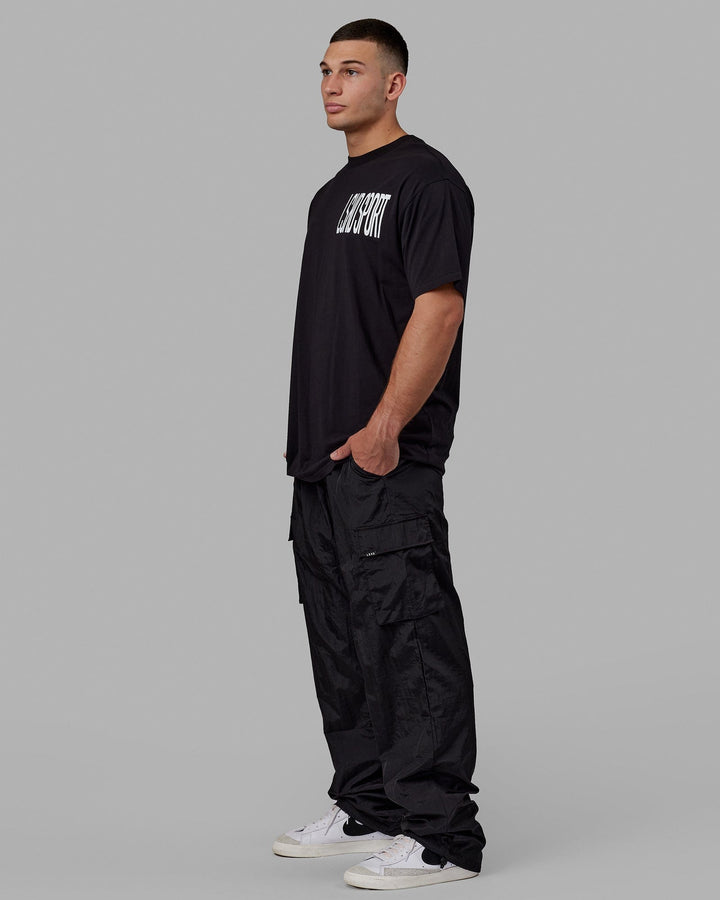 Man wearing Unisex All Day Performance Cargo Pant - Black
