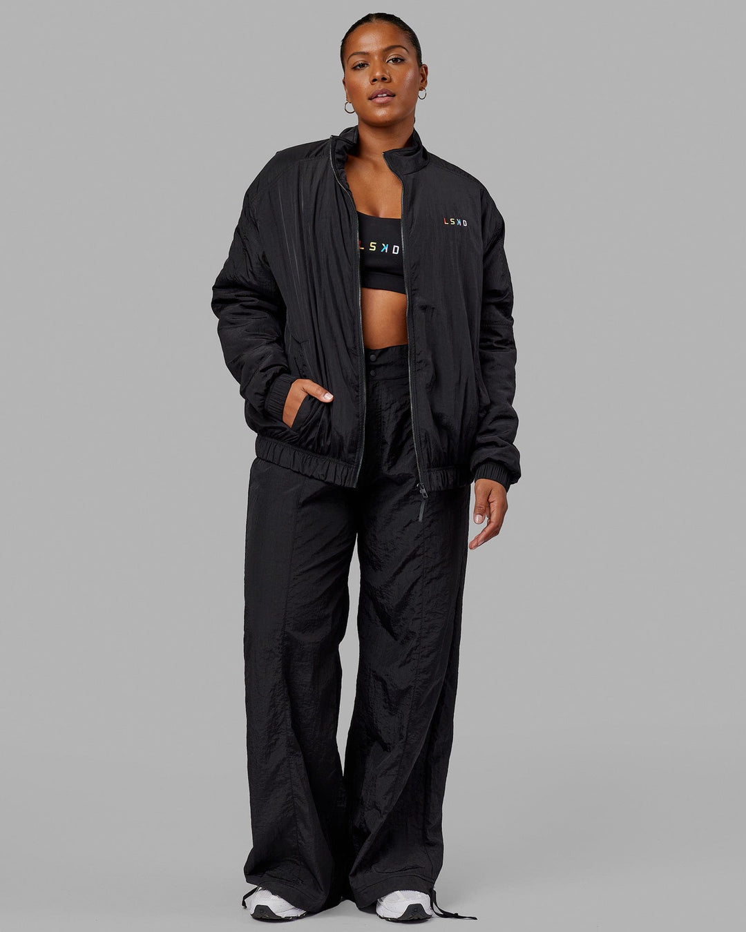 Woman wearing Unisex Amplify Bomber Jacket - Black