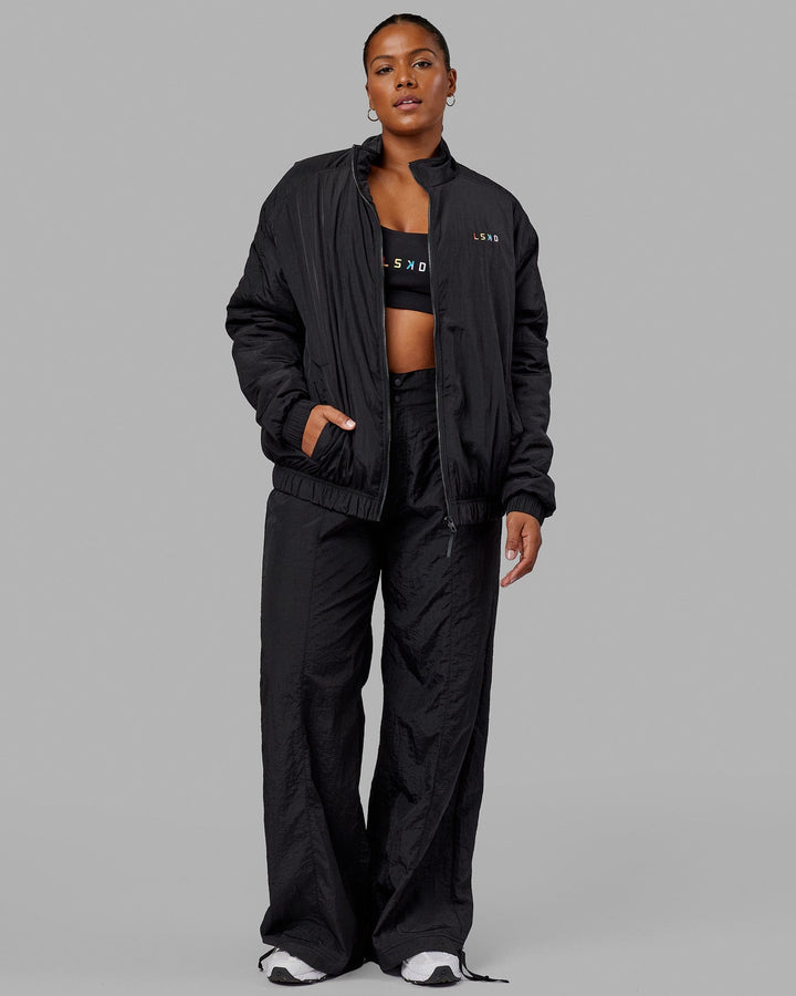 Woman wearing Unisex Amplify Bomber Jacket - Black