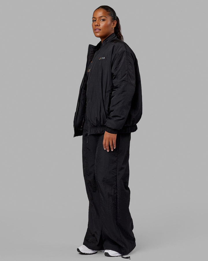Woman wearing Unisex Amplify Bomber Jacket - Black