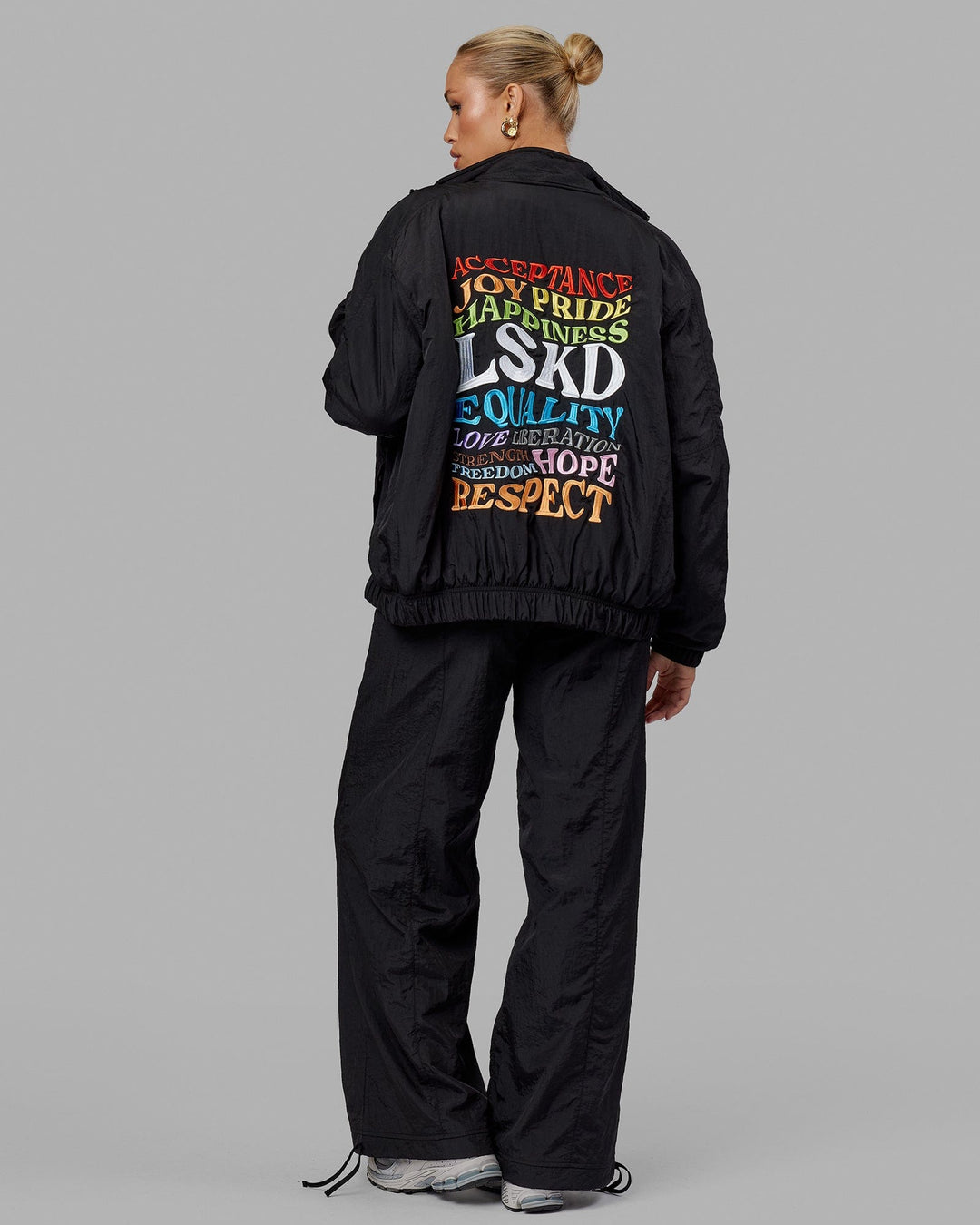 Woman wearing Unisex Amplify Bomber Jacket - Black